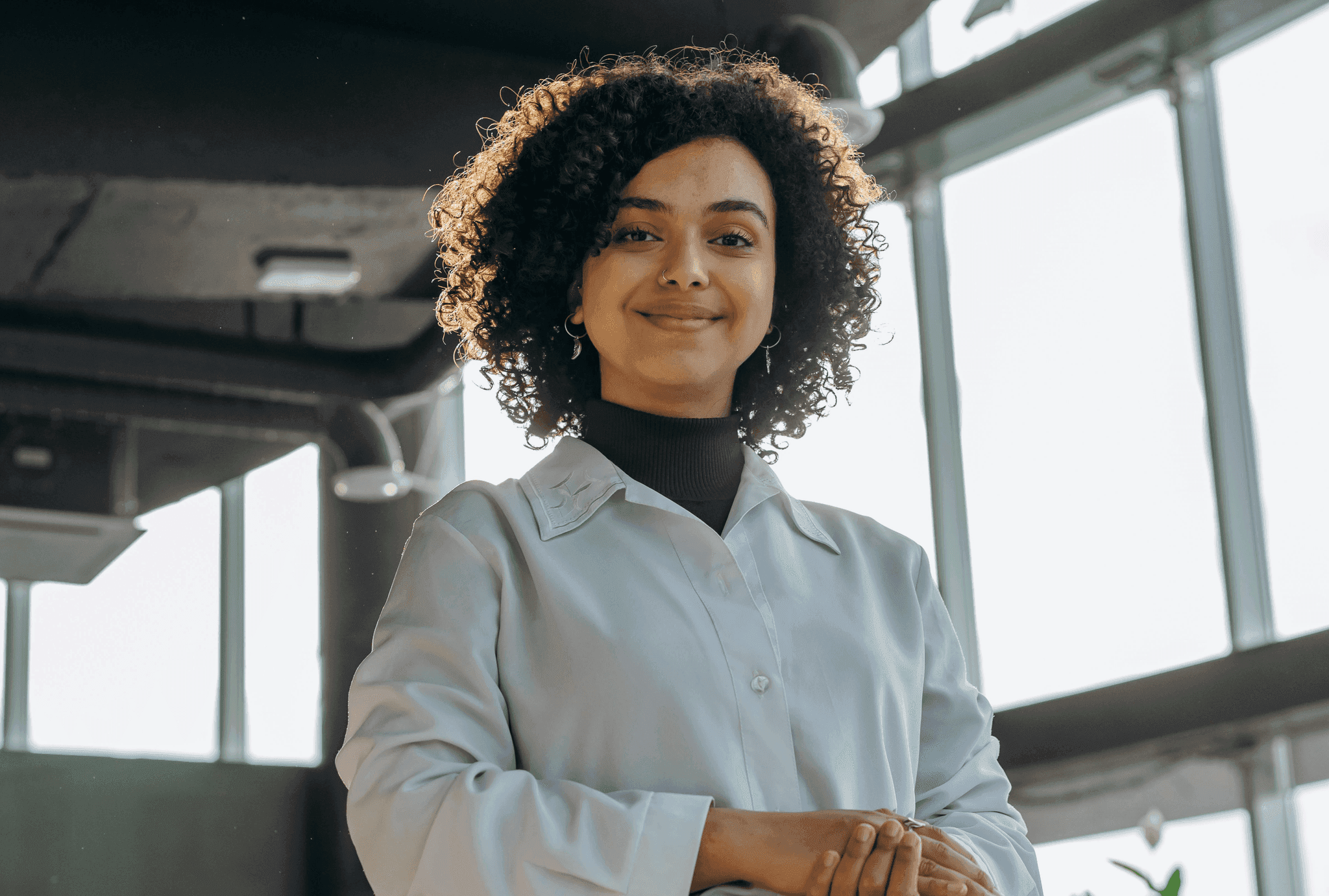 Woman wearing glasses thinking at desk